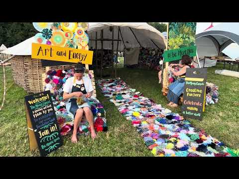 Making mossy pompoms in the sunshine at Glastonbury 2024 with The Mossy Carpet round-house