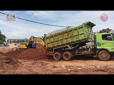 Excavator Earth Digging Activity! Truck tires spinning on mud