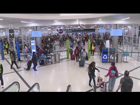 Travelers at Hartsfield-Jackson Atlanta International Airport talk flying on Christmas Eve