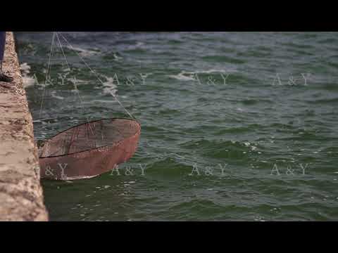 Fisherman catches fish in the sea from the pier.