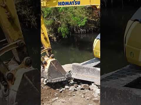 PC78 Komatsu working upper river cleaning debris