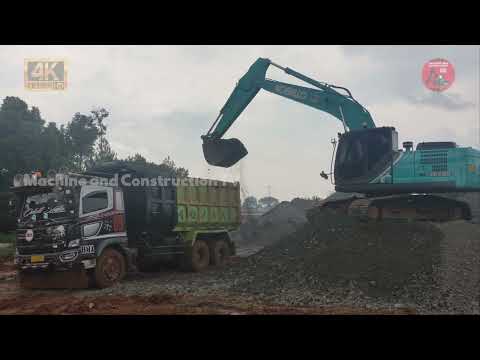 KOBELCO SK200 EXCAVATOR LOADS A LOT OF GRAVEL ONTO THE TRUCK