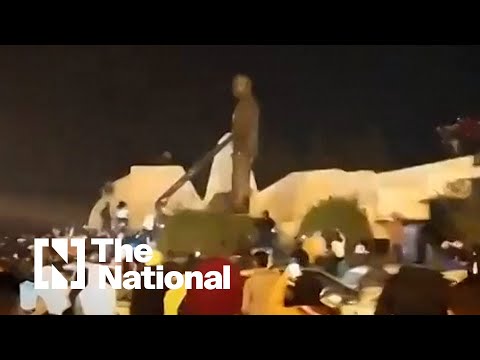 Syrians in Hama tear down statue of the late president Hafez Al Assad