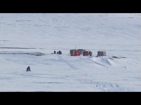 Arriving by snowmobile to Inuit log cabins in the Devon Island - Nanoq 2007 expedition