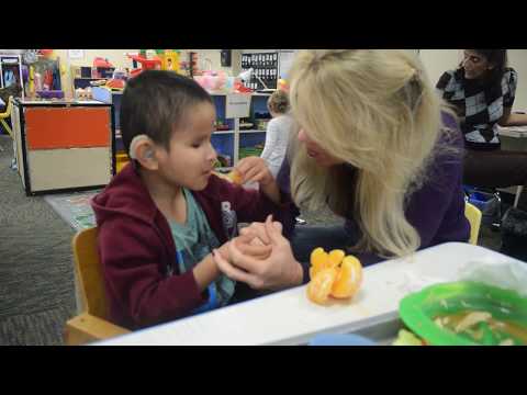 Learning to sign "orange" at Blind Children's Learning Center