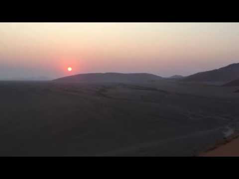 Medicine Man on top of the highest sand dunes in the world playing his Native American Flute Amanda