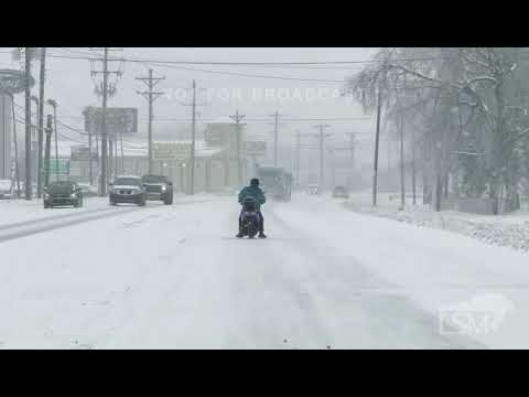 01-06-2025 Louisville, KY - Man riding scooter down snowy road