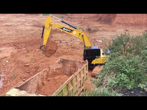 Great Work of Excavator Loading dirt into the Truck in the deepest excavation