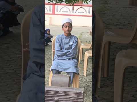 YOUNG BOY RECITING THE QUARAN AT A CHARITABLE INSTITUTION