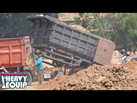 dumper trucks queue for unloading dirt on a toll road project