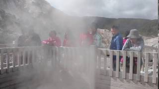 Tourists watch a geyser in Noboribetsu, Hokkaido, Japan