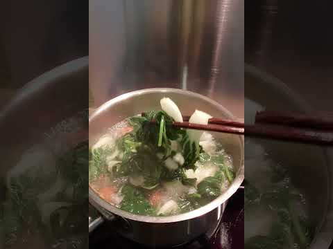 Boiling sweet potato leaves with meat balls for my noodles #followers #highlights