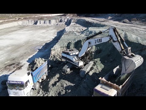 Caterpillar 375 Excavator Loading Trucks With Three Passes - Aerial View