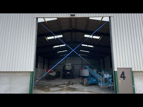 Wind proofing a steel farm roller shutter door.