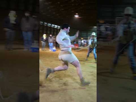 8 cowboys try to restrain 1 man with ropes