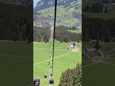 Spectacular view of the Titlis Cableway over the verdant valley of Engelberg in Switzerland!