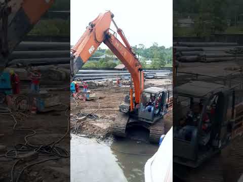 Excavator moving Rubber baloon for a ship