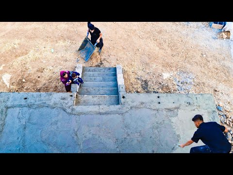 A scene of love and effort; concreting the stairs of the house with the hands of Ibrahim and Soghra