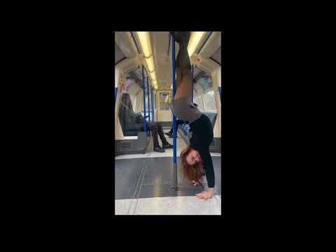 Doing a Handstand on a Train In Boots and Black Pantyhose