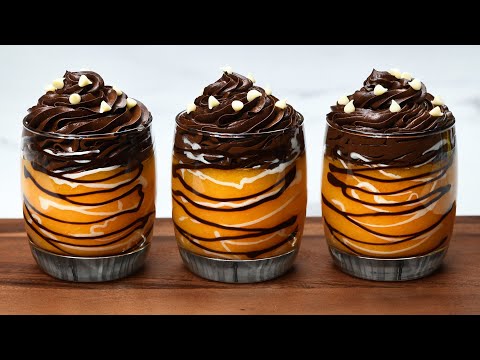 Delicious chocolate dessert with oranges in cups.