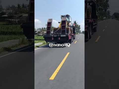 Big Hino trailer truck transporting big Loader to project site