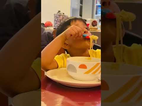 Kid eating noodles