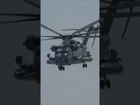 A CH-53 rushes in! A large helicopter with a US Marine Corps assault team.