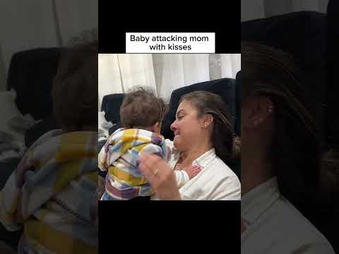 Baby attacking mom with kisses