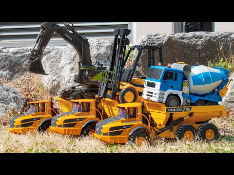 There are three Volvo trucks and a forklift excavator mixer truck  Let's take a look together