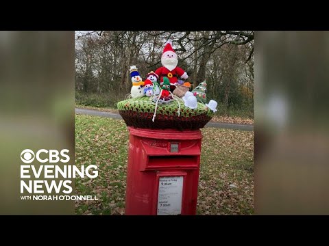 Britain's iconic red mailboxes get holiday decorations