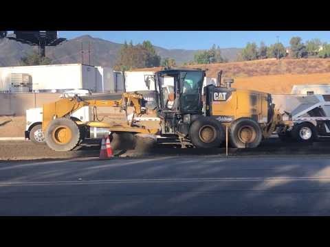 The CAT Motor Grader (the "blade") cuts street subgrade