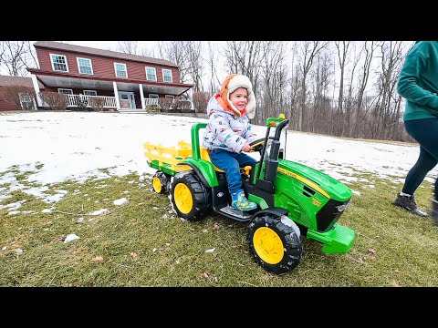 we feed the deer using his John Deere toy tractor and wagon