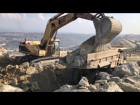 Caterpillar 375 Excavator Loading Huge Rocks On Caterpillar Dumper - Sotiriadis/ Labrianidis Mining