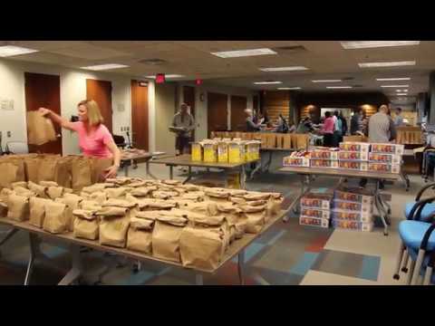 SFM employees pack lunches for Sharing and Caring Hands