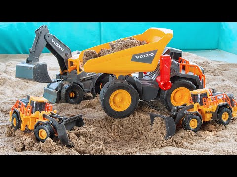 Bulldozers and excavators fill the mega dump truck with sand, and the dump truck carries sand