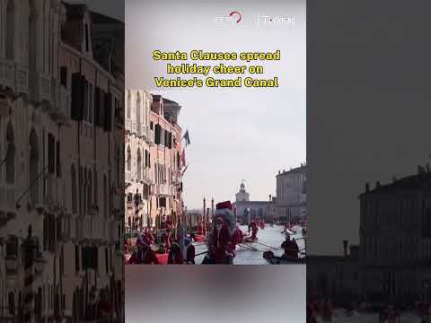 Santa Clauses spread holiday cheer on Venice's Grand Canal