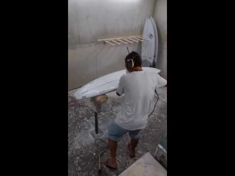 Grinding a surfboard lap before a bottom hotcoat.