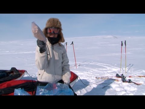 Ingrid unearhting the food of the portage from the snow - Penny Icecap 2009 expedition