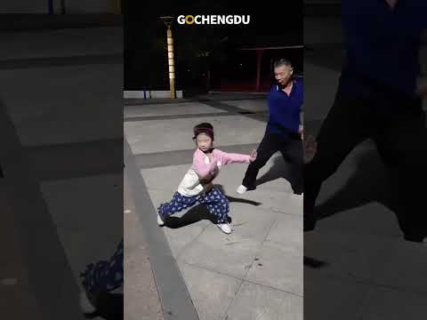 A grandpa teaches his granddaughter Chinese kung fu.