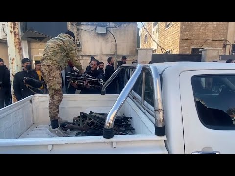 Former soldiers and police surrender weapons in Syria's Hama City