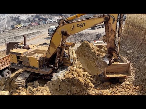 Old Hero in Action: Caterpillar 245B Excavator with Over 120,000 Working Hours Loading Overburden