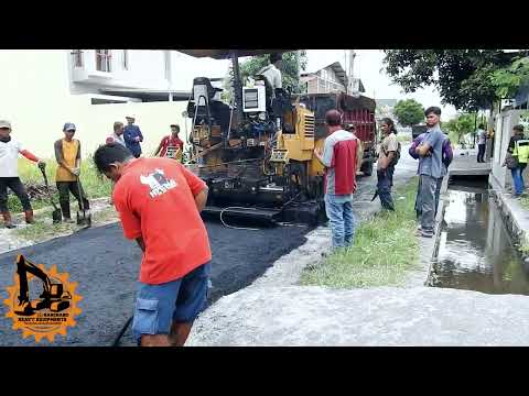 asphalt paver cat making new asphalt road with dumper truck