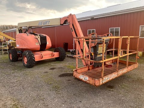 Loading a DEAD JLG Manlift with Cat Excavator