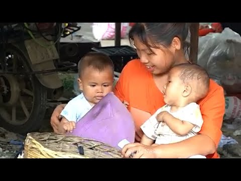 Single mother harvests grapefruit, bananas and makes yogurt for her children.