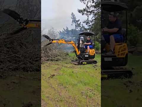 miva va16s excavator loading brush into a burn pile