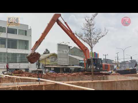 Hitachi Long Reach Excavator digging dirt in Underpass Road Construction