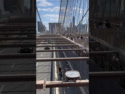 The elevated pedestrian walkway on the Brooklyn Bridge offers a great view of the East River!