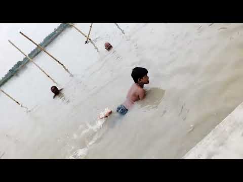 I am taking a bath at the Ganga ghat in Mayapur.