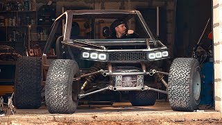 Wow! A man is building a unique all-terrain vehicle in a garage!