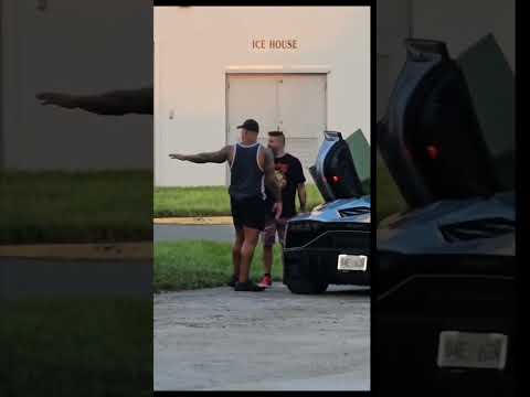 Kevin Owens shows his Lamborghini to Randy Orton